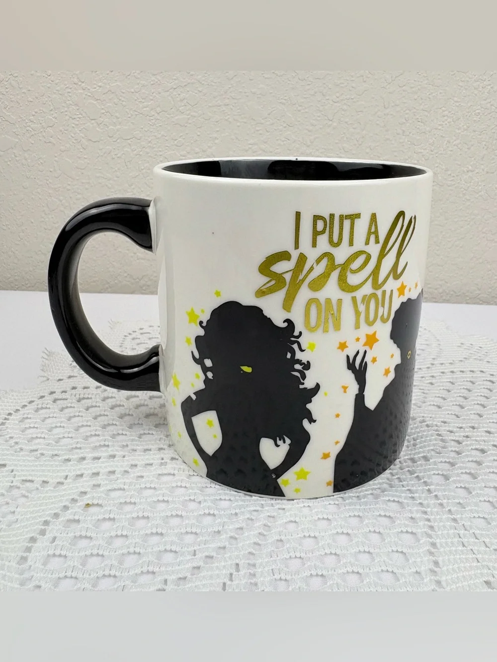 Disney Hocus Pocus Ceramic Mug with a Candle Inside the Mug.